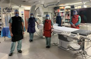 health-care professionals gathered around procedure table