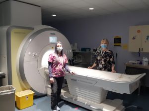 health-care professionals next to MRI equipment