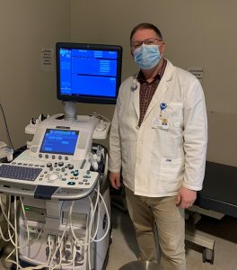 health-care professional standing next to ultrasound equipment